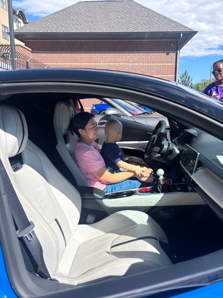 Adult and toddler sitting together in a Lotus